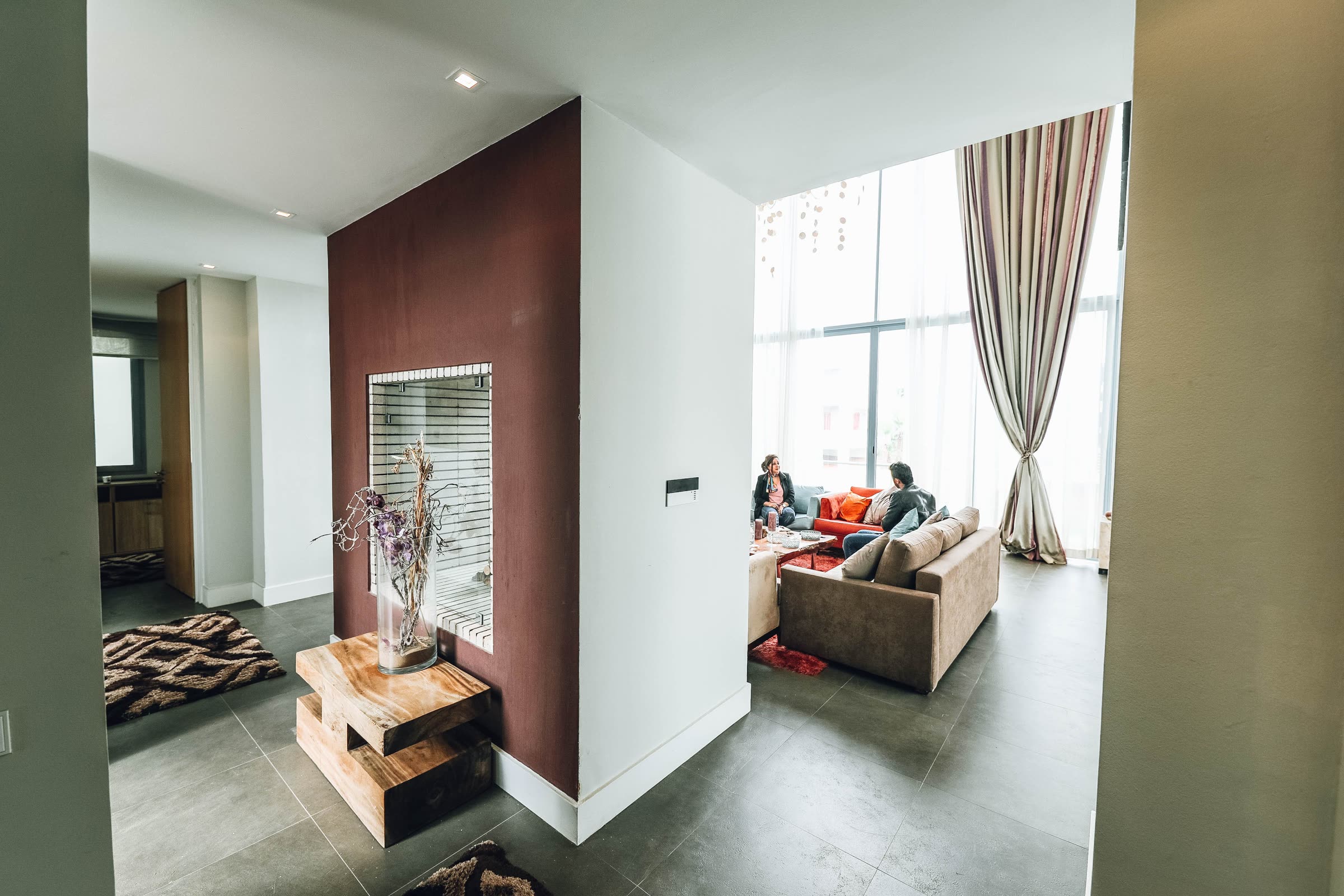 Two people relaxing together in a bright, tidy living room