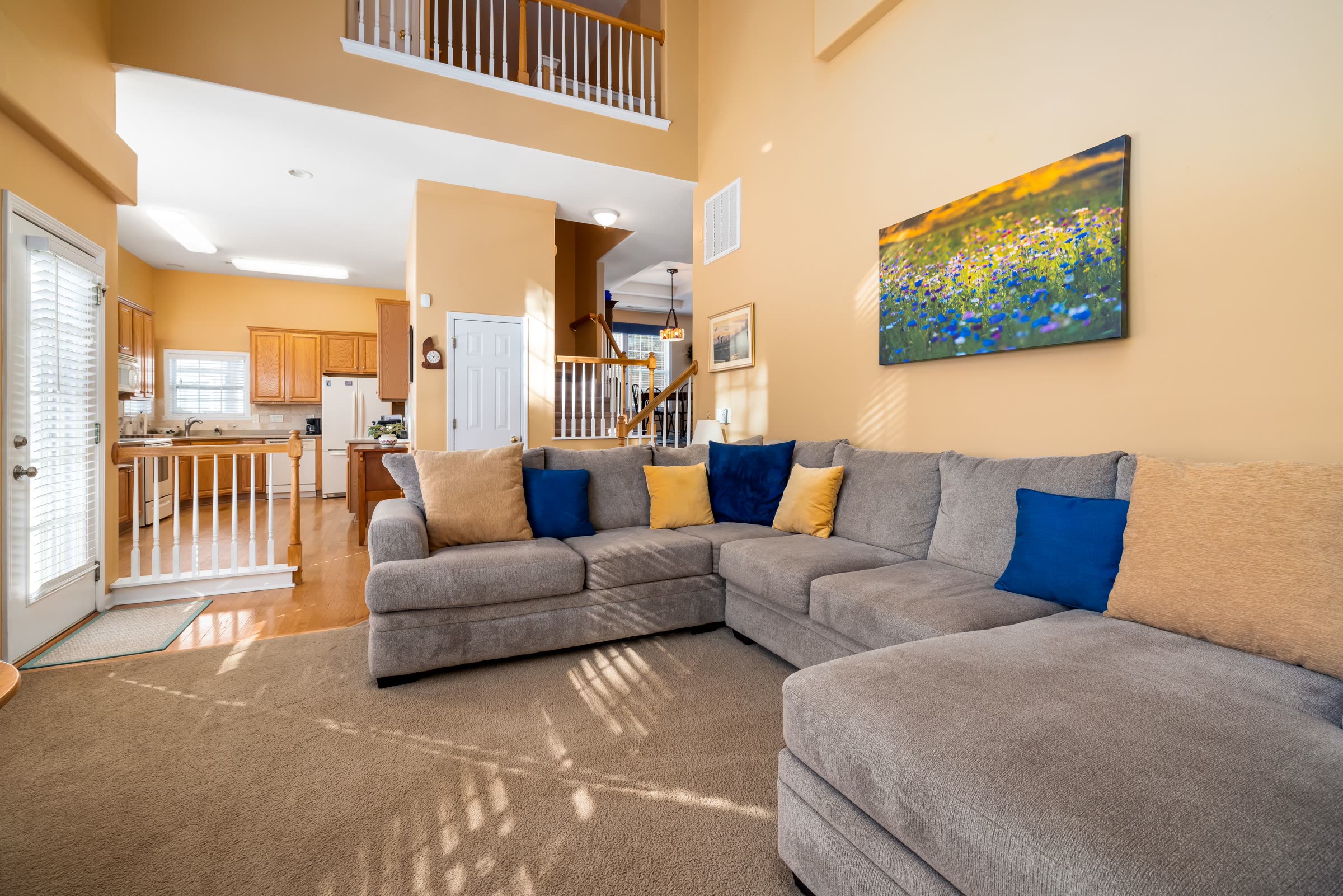 A calm, finished living room and open kitchen representing the Elevated experience