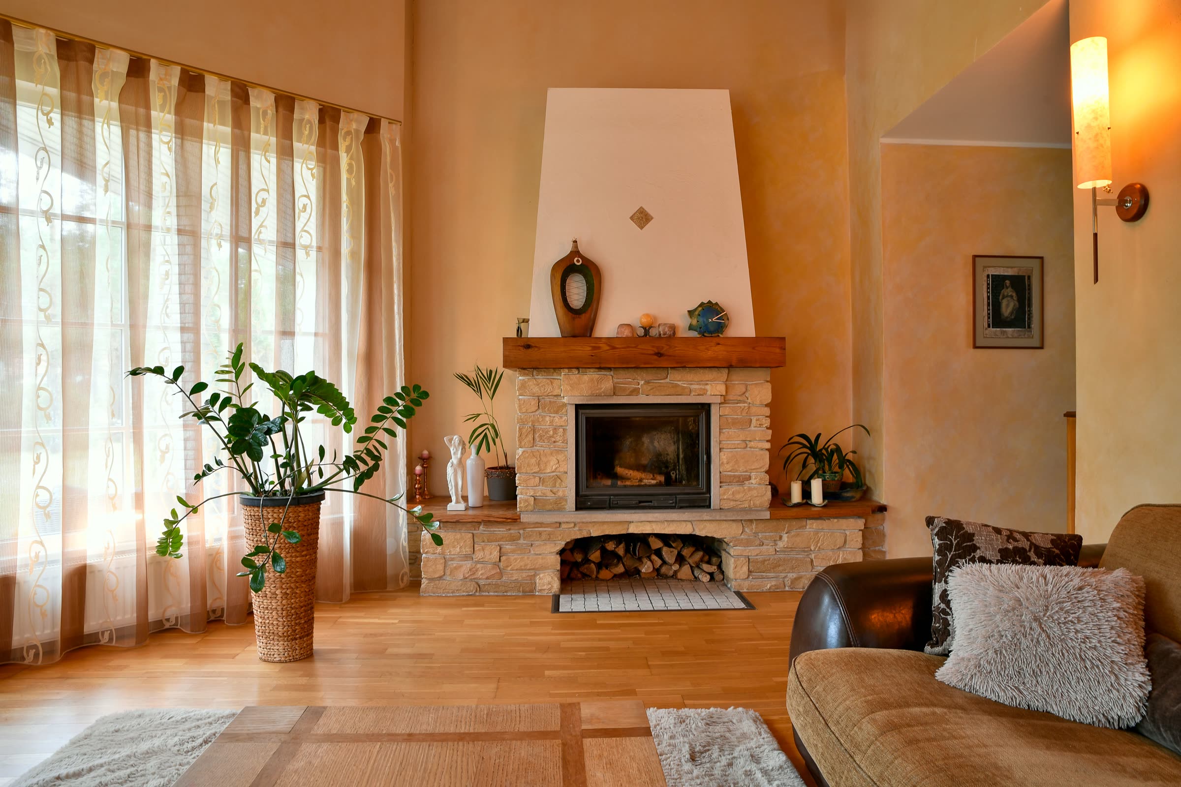 A freshly cleaned, warm living room with a lit fireplace