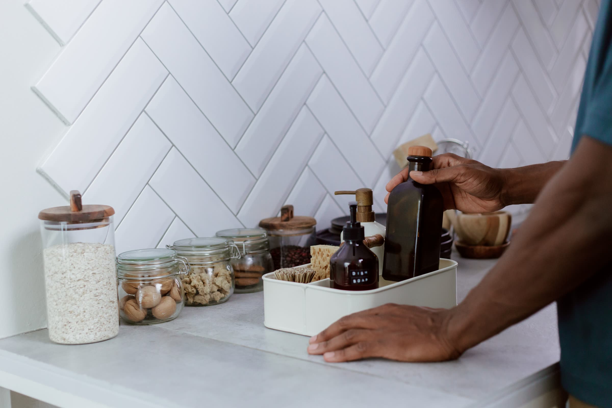 Everyday kitchen items being sorted into a countertop caddy