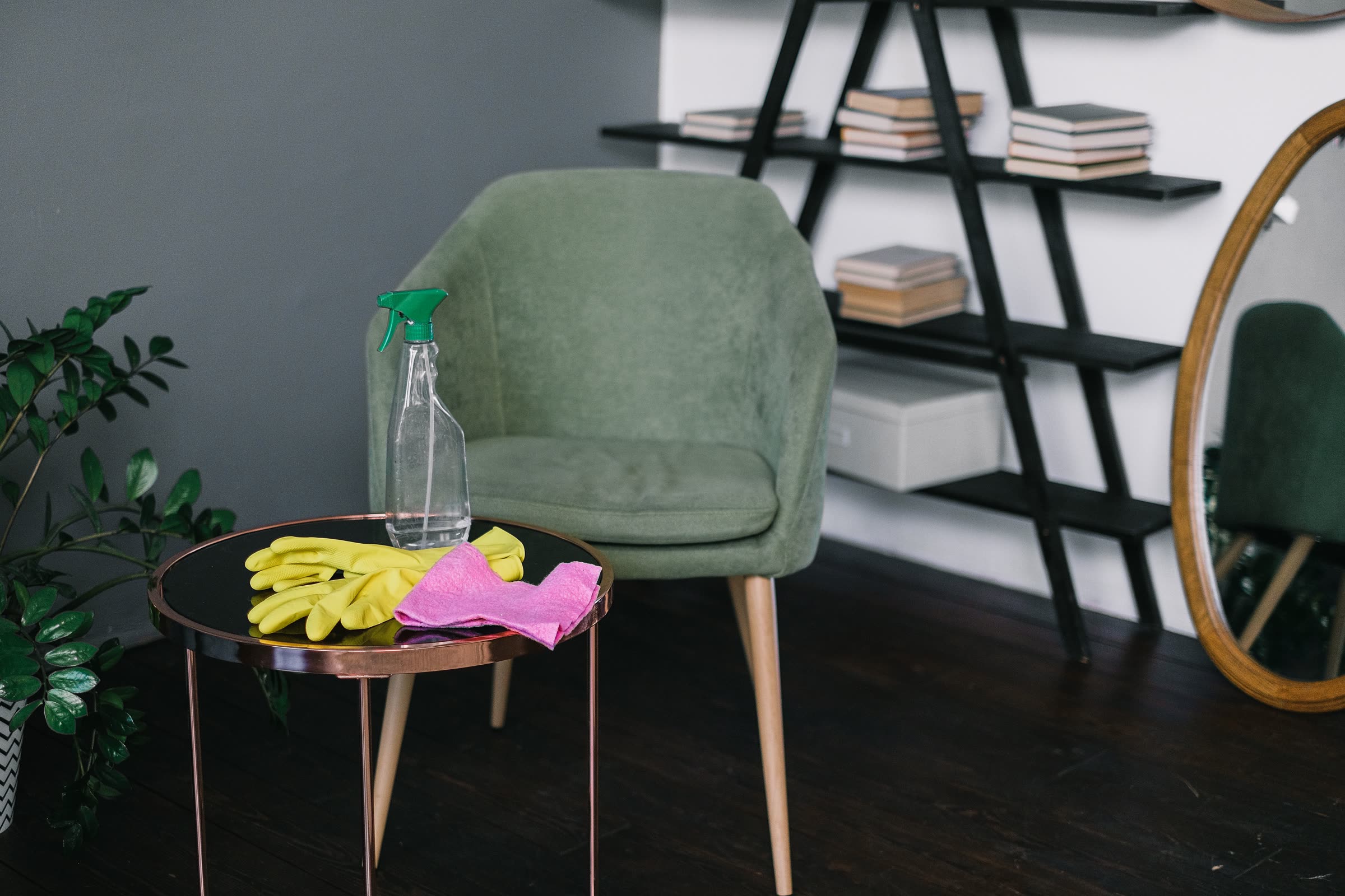 Cleaning supplies — gloves, a spray bottle, and a cloth — set out and ready to use