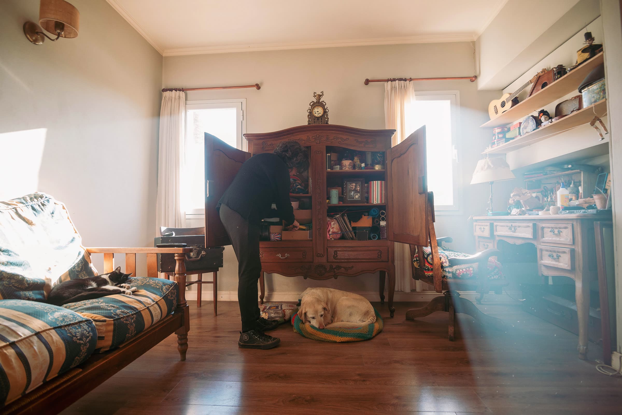 Sorting and organizing belongings into a cabinet in a client's home
